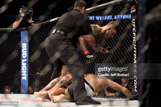 Cody Garbrandt is pulled off Takeya Mizugaki of Japan to win their bantamweight bout during the UFC 202 event at T-Mobile Arena on August 20, 2016 in...