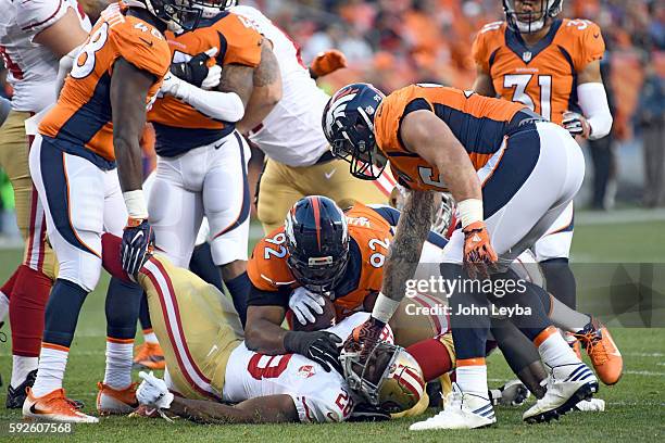 Denver Broncos nose tackle Sylvester Williams and Denver Broncos defensive end Derek Wolfe put a stop on San Francisco 49ers running back Carlos Hyde...