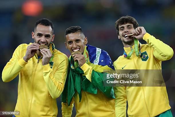 Renato Augusto of Brazil, Marquinhos of Brazil and Rodrigo Caio of Brazil celebrate with their medals following the Men's Football Final between...