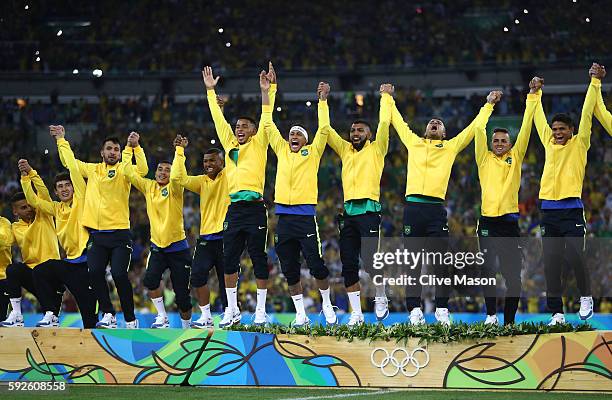 Brazil line up to receive their gold medals after winning the Men's Football Final between Brazil and Germany at the Maracana Stadium on Day 15 of...