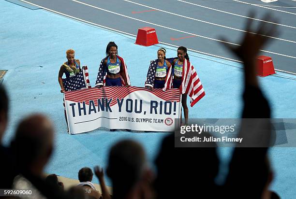 Natasha Hastings, Phyllis Francis, Allyson Felix and Courtney Okolo of the United States react after winning gold in the Women's 4 x 400 meter Relay...