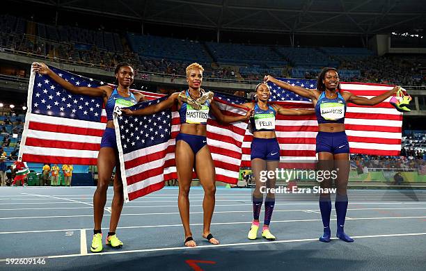 Courtney Okolo, Natasha Hastings, Allyson Felix and Phyllis Francis of the United States react after winning gold in the Women's 4 x 400 meter Relay...