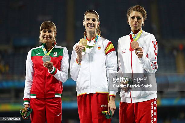 Silver medalist Mirela Demireva of Bulgaria, gold medalist Ruth Beitia of Spain and bronze medalist Blanka Vlasic of Croatia stand on the podium...