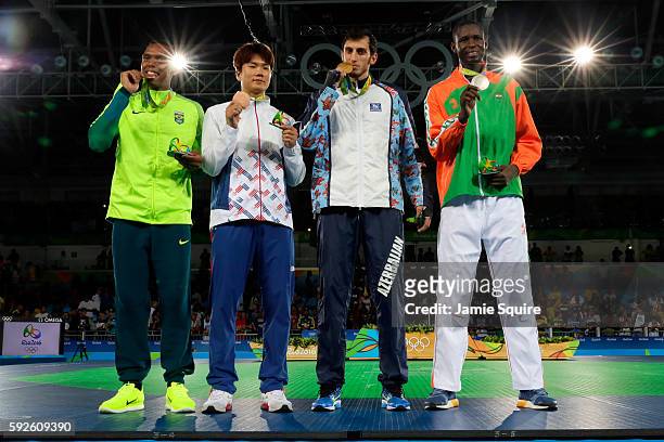 Silver medalist Abdoulrazak Issoufou Alfaga of Niger, Gold medalist Radik Isaev of Azerbaijan and Bronze medalists Dongmin Cha of Korea and Maicon...