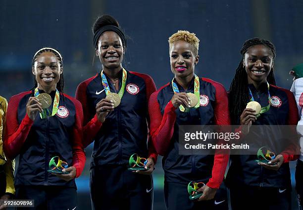 Gold medalists Courtney Okolo, Natasha Hastings, Allyson Felix and Phyllis Francis of the United States stand on the podium during the medal ceremony...
