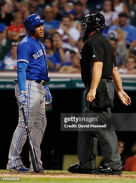 Ezequiel Carrera of the Toronto Blue Jays exchanges words with home plate umpire Greg Gibson after a called third strike in the game against the...