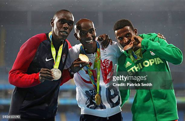 Silver medalist Paul Kipkemoi Chelimo of the United States, gold medalist Mohamed Farah of Great Britain and bronze medalist Hagos Gebrhiwet of...