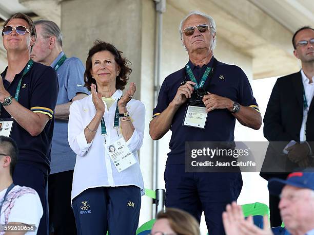 Queen Silvia of Sweden and King Carl XVI Gustaf of Sweden celebrate the silver medal of swedish rider Peder Fredricson in the Jumping Individual...