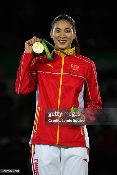 Gold medalist Shuyin Zheng of China celebrates on the podium during the medal ceremony for the Taekwondo Women +67kg Gold Medal Contest on Day 15 of...