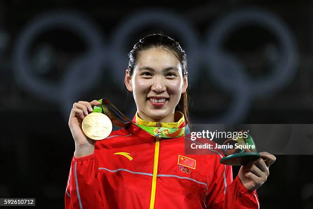 Gold medalist Shuyin Zheng of China celebrates on the podium during the medal ceremony for the Taekwondo Women +67kg Gold Medal Contest on Day 15 of...