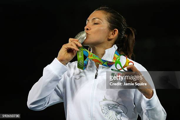 Silver medalist Maria del Rosario Espinoza Espinoza of Mexico celebrates on the podium during the medal ceremony for the Taekwondo Women +67kg Gold...