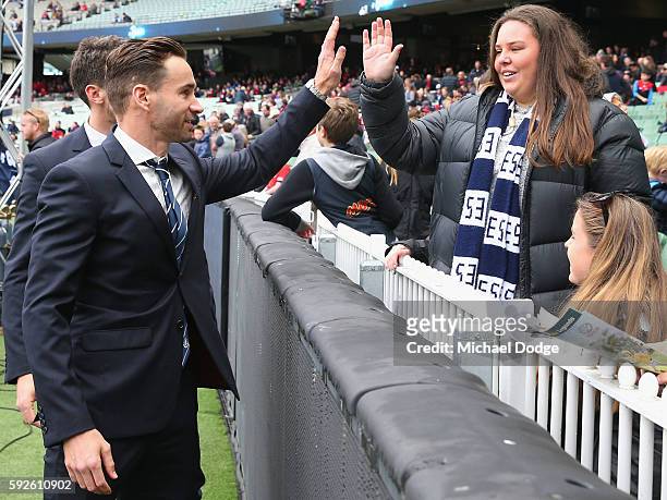 The retired Andrew Walker of the Blues walks a lap of honour during the round 22 AFL match between the Carlton Blues and the Melbourne Demons at...