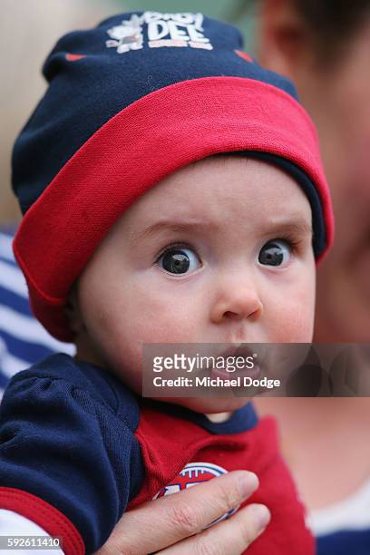 Baby Demons fan watches his first match during the round 22 AFL match between the Carlton Blues and the Melbourne Demons at Melbourne Cricket Ground...