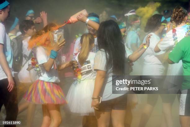 People participate in the annual Color Run in Centennial Park in Sydney on August 21, 2016. The Color Run is a 5km fun run started in the US in 2012...