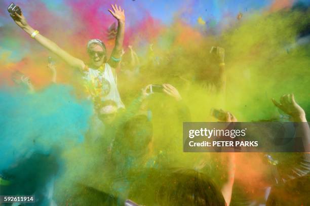 People participate in the annual Color Run after party in Centennial Park in Sydney on August 21, 2016. The Color Run is a 5km fun run started in the...