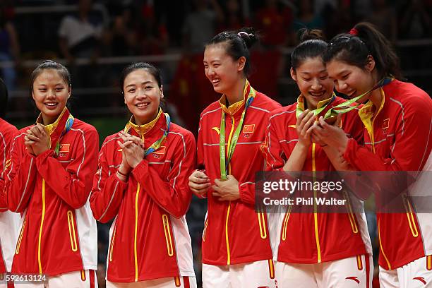 Team China celebrates on the podium after winning gold during the Women's Gold Medal Match between Serbia and China on Day 15 of the Rio 2016 Olympic...