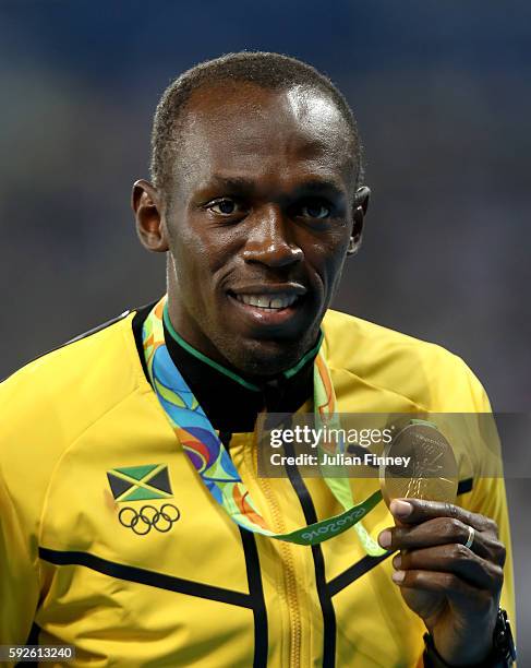 Gold medalist Usain Bolt of Jamaica stands on the podium during the medal ceremony for the Men's 4 x 100 meter Relay on Day 15 of the Rio 2016...