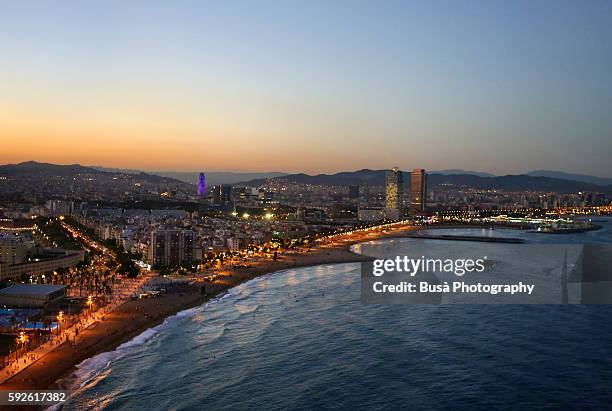 bird's eye view of the barcelona bay at twilight, from the top of the w hotel. barcelona, catalonia, spain - barcellona night foto e immagini stock