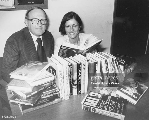 Broadcasters Diana Quick and Robert Robinson, co-presenters of the new BBC 2 show 'Word for Word', pictured reading books at BBC Television Centre on...