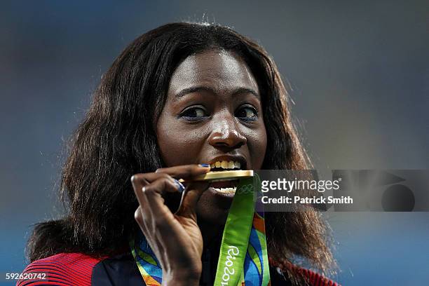 Gold medalist Tori Bowie of the United States stands on the podium during the medal ceremony for the Women's 4 x 100 meter Relay on Day 15 of the Rio...