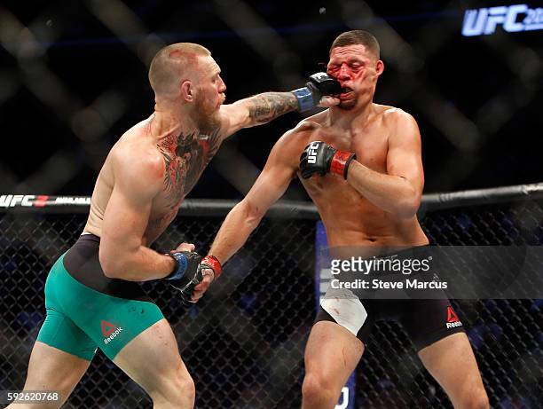 Conor McGregor hits Nate Diaz with a left during their welterweight rematch at the UFC 202 event at T-Mobile Arena on August 20, 2016 in Las Vegas,...