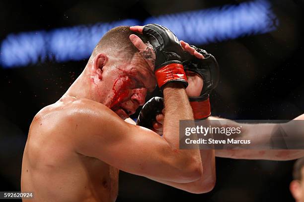 Nate Diaz takes a punch from Conor McGregor during their welterweight rematch at the UFC 202 event at T-Mobile Arena on August 20, 2016 in Las Vegas,...