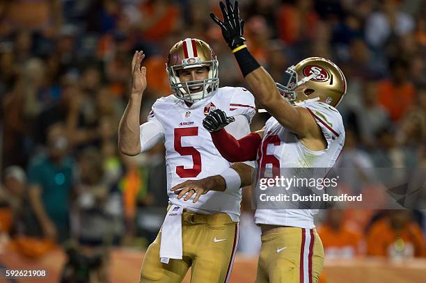 Christian Ponder of the San Francisco 49ers celebrates with wide receiver Devon Cajuste after scoring a fourth quarter rushing touchdown against the...