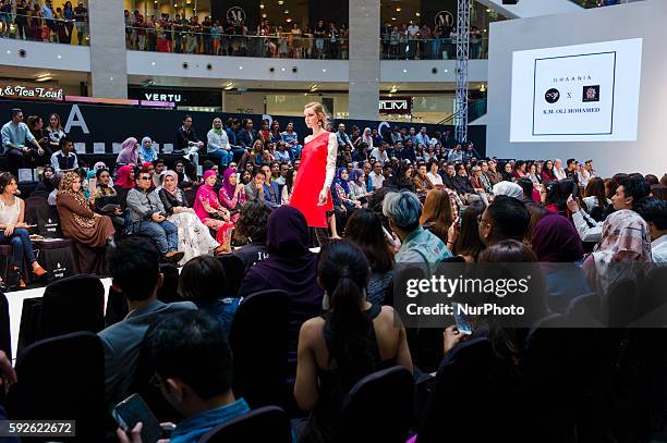 Models presents creations by designer GHANIA X K.M. OLI MOHAMED during the fashion showcase of the 2016 Kuala Lumpur Fashion week at Pavilion Kuala...