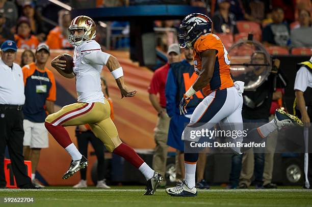 Christian Ponder of the San Francisco 49ers rushes away from linebacker Eddie Yarbrough of the Denver Broncos to score a fourth quarter rushing...