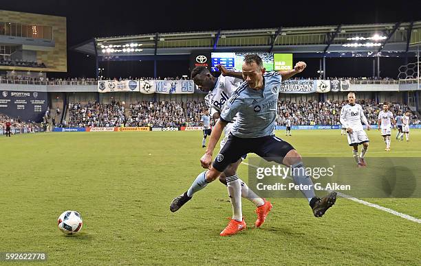 Mid-fielder Brad Davis of Sporting Kansas City has the ball taken away against defender Alphonso Davies of the Vancouver Whitecaps FC during the...
