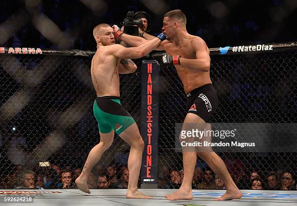 Nate Diaz punches Conor McGregor in their welterweight bout during the UFC 202 event at T-Mobile Arena on August 20, 2016 in Las Vegas, Nevada.