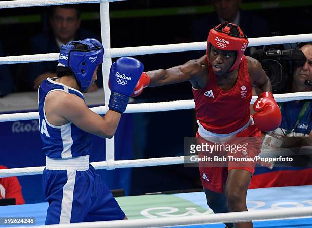 Nicola Adams of Great Britain lands a blow during the Women's Fly Final Bout against Sarah Ourahmoune of France on Day 15 of the Rio 2016 Olympic...