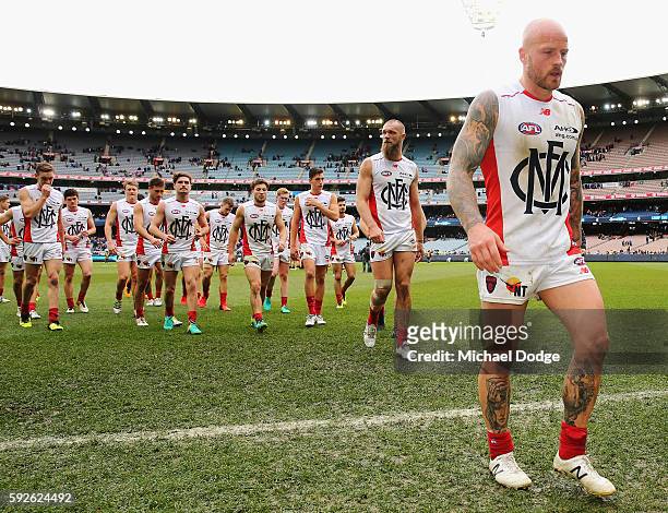Nathan Jones of the Demons leads the team off after defeat during the round 22 AFL match between the Carlton Blues and the Melbourne Demons at...