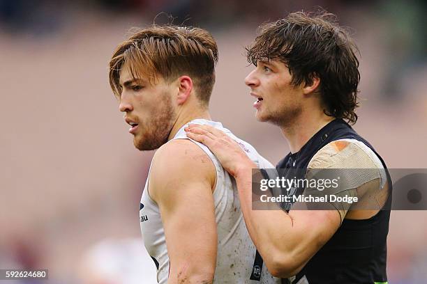 Victorious Dylan Buckley of the Blues speaks to Jack Viney of the Demons who looks dejected after defeat after the final siren during the round 22...