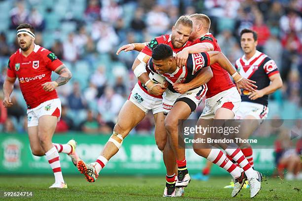 Daniel Tupou of the Roosters is tackled by the Dragons defence during the round 24 NRL match between the Sydney Roosters and the St George Illawarra...