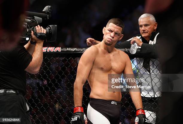 Nate Diaz eyes Conor McGregor from across the Octagon before their welterweight rematch at the UFC 202 event at T-Mobile Arena on August 20, 2016 in...