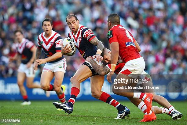 Blake Ferguson of the Roosters breaks the Dragons defence during the round 24 NRL match between the Sydney Roosters and the St George Illawarra...