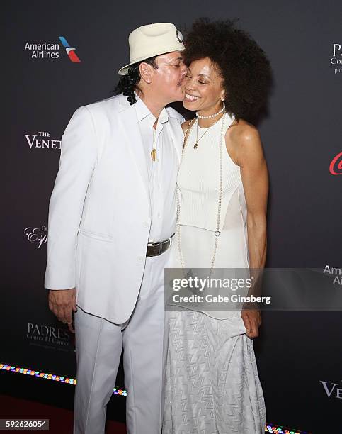 Recording artist Carlos Santana kisses his wife, drummer Cindy Blackman, as they attend the Padres Contra El Cancer's 16th annual "El Sueno de...