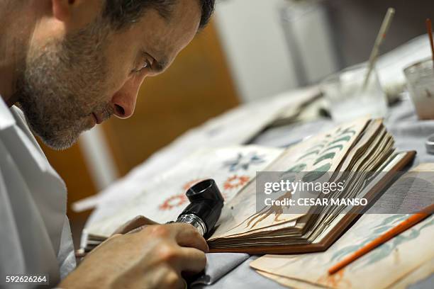 Quality control operator of the Spanish publishing outfit Siloe Luis Miguel works on cloning the illustrated codex hand-written manuscript Voynich in...
