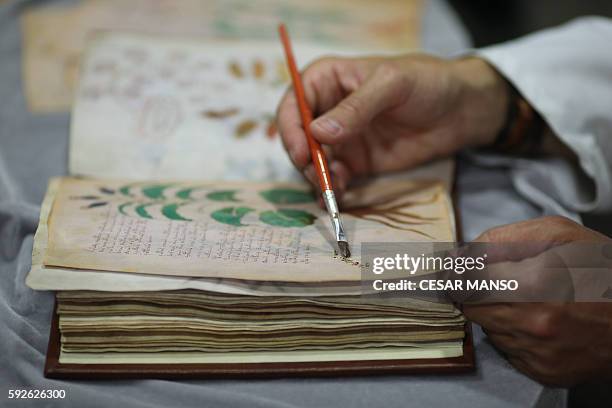 Quality control operator of the Spanish publishing outfit Siloe Luis Miguel works on cloning the illustrated codex hand-written manuscript Voynich in...