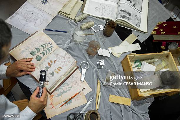 Quality control operator of the Spanish publishing outfit Siloe Luis Miguel works on cloning the illustrated codex hand-written manuscript Voynich in...