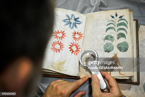Quality control operator of the Spanish publishing outfit Siloe Luis Miguel works on cloning the illustrated codex hand-written manuscript Voynich in...