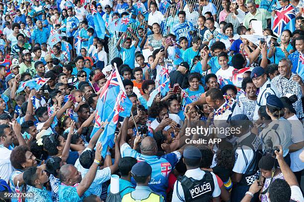Fans greet Fiji's Olympic gold-medal-winning men's sevens rugby team on their return from Rio, at Prince Charles Park in Nadi on August 21, 2016. The...