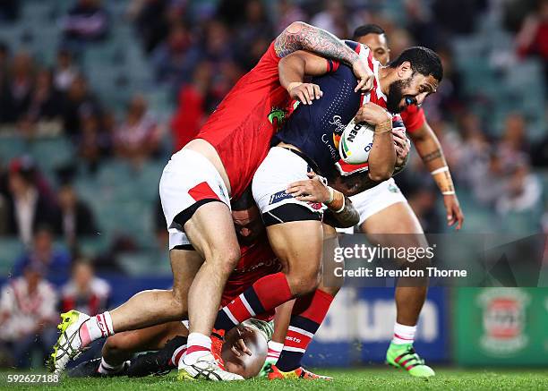 Isaac Liu of the Roosters is tackled by the Dragons defence during the round 24 NRL match between the Sydney Roosters and the St George Illawarra...