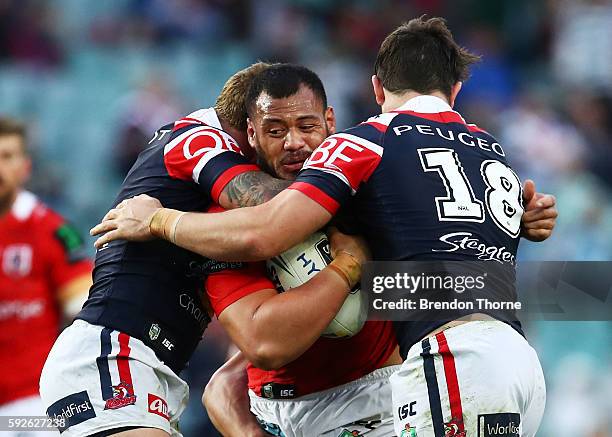 Leeson Ah Mau of the Dragons is tackled by Roosters defence during the round 24 NRL match between the Sydney Roosters and the St George Illawarra...