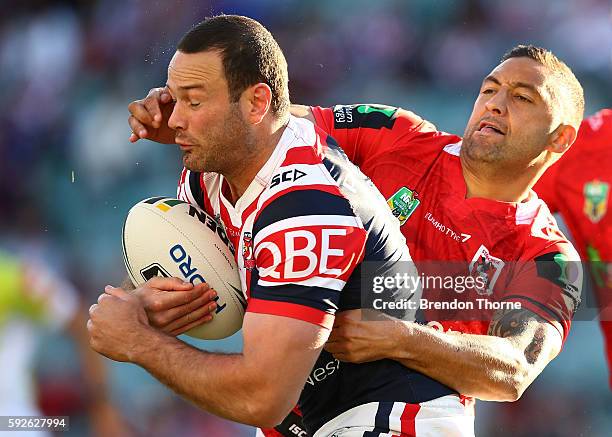 Boyd Cordner of the Roosters is tackled by Benji Marshall of the Dragons during the round 24 NRL match between the Sydney Roosters and the St George...