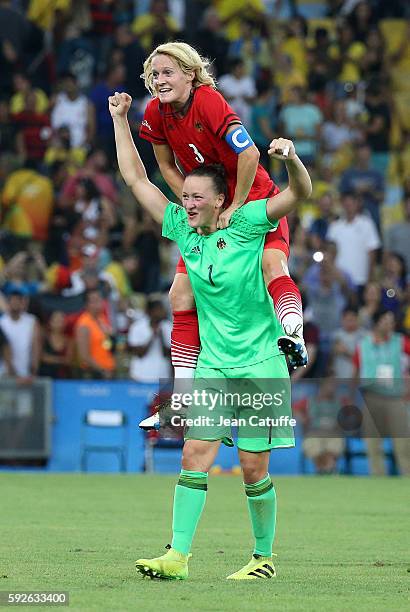 Saskia Bartusiak and goalkeeper of Germany Almuth Schult of Germany celebrate winning the gold medal in the Women's Soccer Final between Germany and...