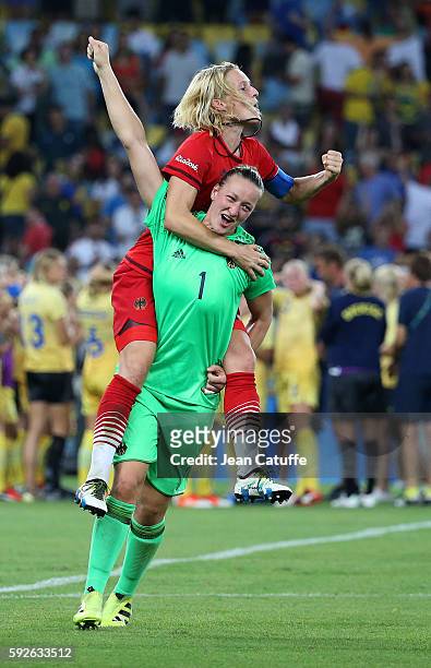 Saskia Bartusiak and goalkeeper of Germany Almuth Schult of Germany celebrate winning the gold medal in the Women's Soccer Final between Germany and...