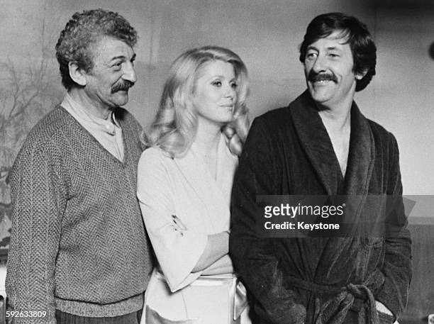 Director Yves Robert and actors Catherine Deneuve and Jean Rochefort on the set of the film 'Courage Fuyons', circa 1979.