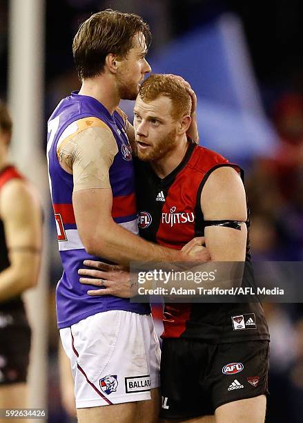 Jordan Roughead of the Bulldogs congratulates former teammate Adam Cooney of the Bombers after his 250th and final game during the 2016 AFL Round 22...